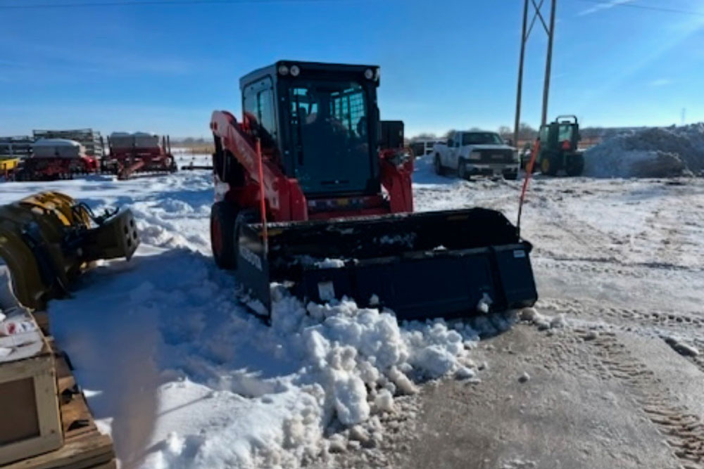 skid steer with snow plow attachment